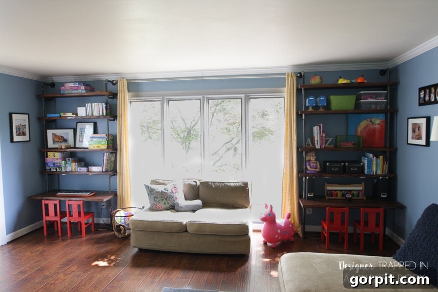 Full view of the DIY industrial pipe shelves and desks in a playroom