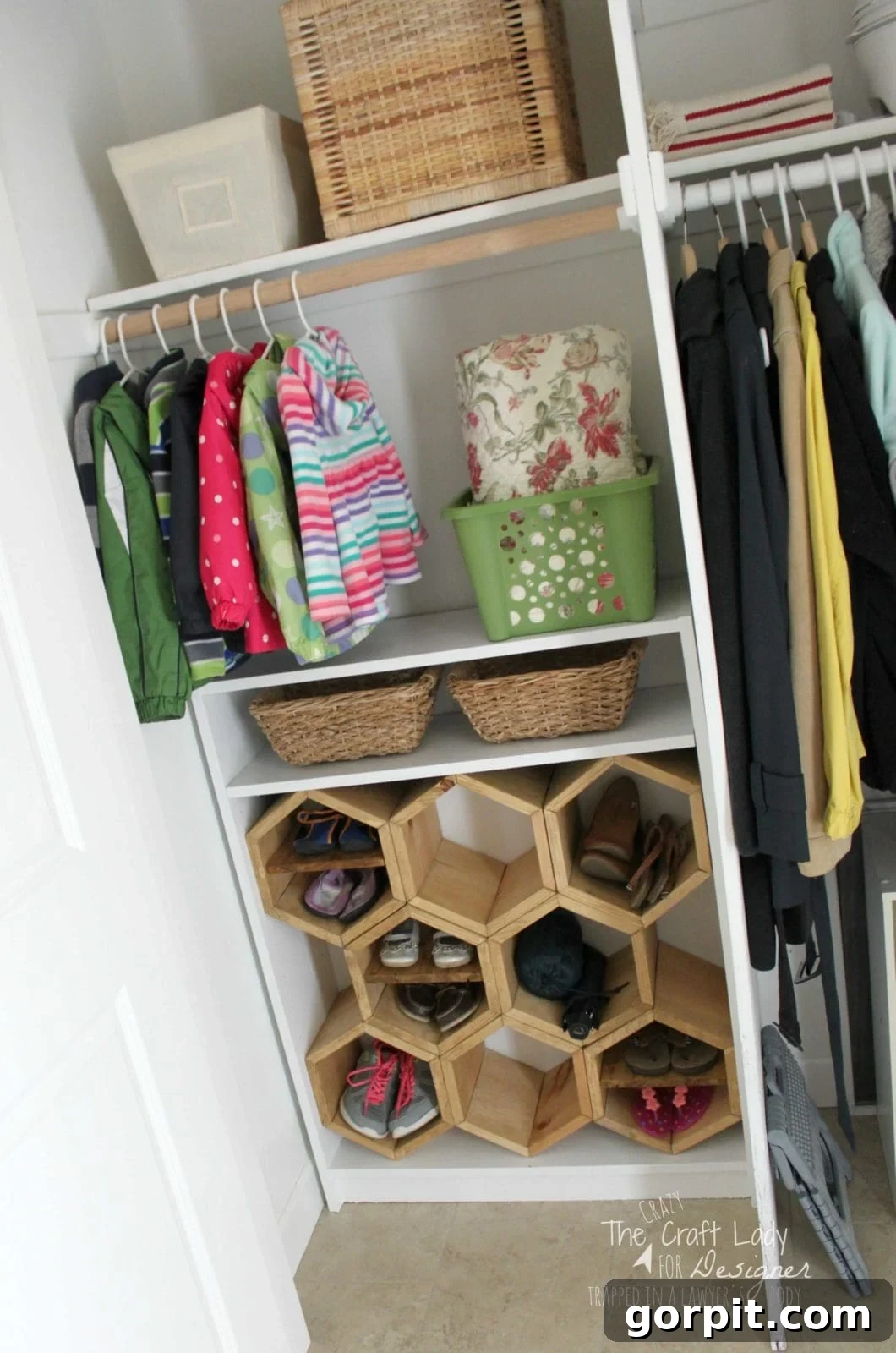 Honeycomb Shoe Rack DIY 19 A slanted picture of an open, organized entry way closet holding hanging clothes, wicker basket storage, and a bookcase turned into a DIY shoe rack with hexagonal wooden shoe cubbies. The lower right corner has text that reads,