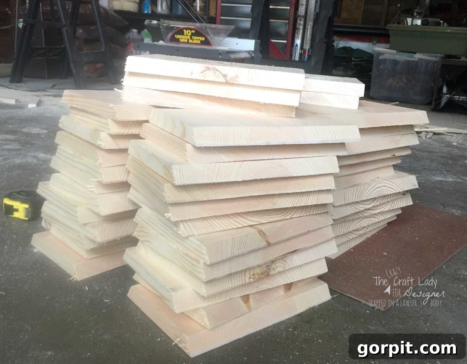 Honeycomb Shoe Rack DIY 9 A sawdust covered garage floor with a large pile of light wood, freshly cut squares ready to be assembled into hexagons. The DIY shoe rack will used the hexagonal shoe cubbies for neat and unique storage.