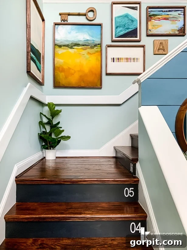 DIY Staircase Makeover: Hardwood Installation Guide 11 A vibrant gallery wall with custom DIY frames complementing the new hardwood stairs, adding a personalized touch to the entryway.