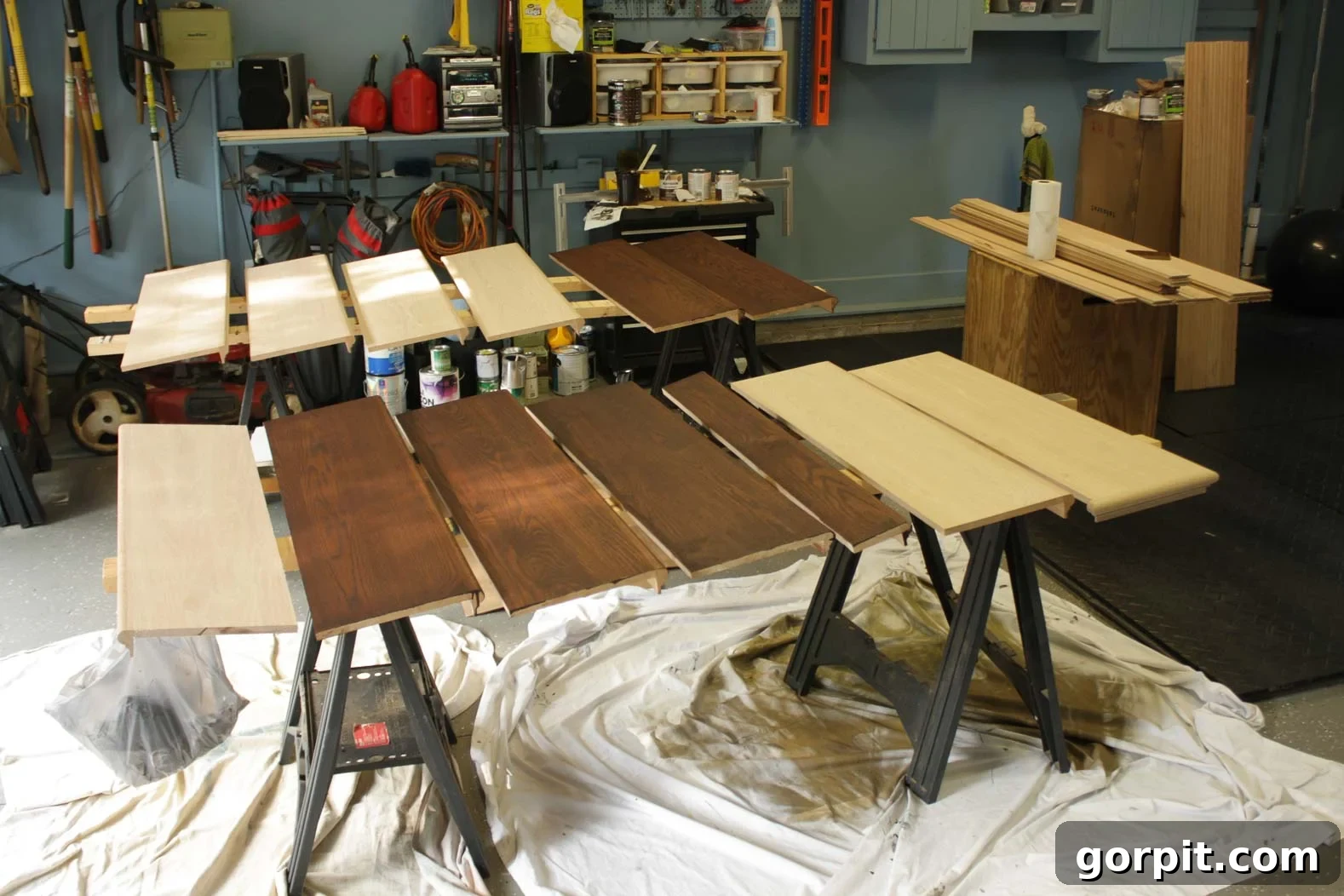 Close-up of new hardwood stair treads being stained to match existing home decor.