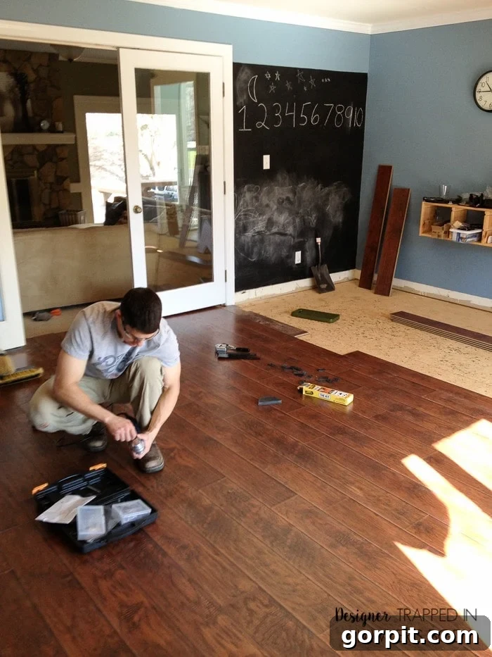 Close-up of newly installed laminate flooring, highlighting its realistic wood grain texture and durable surface.