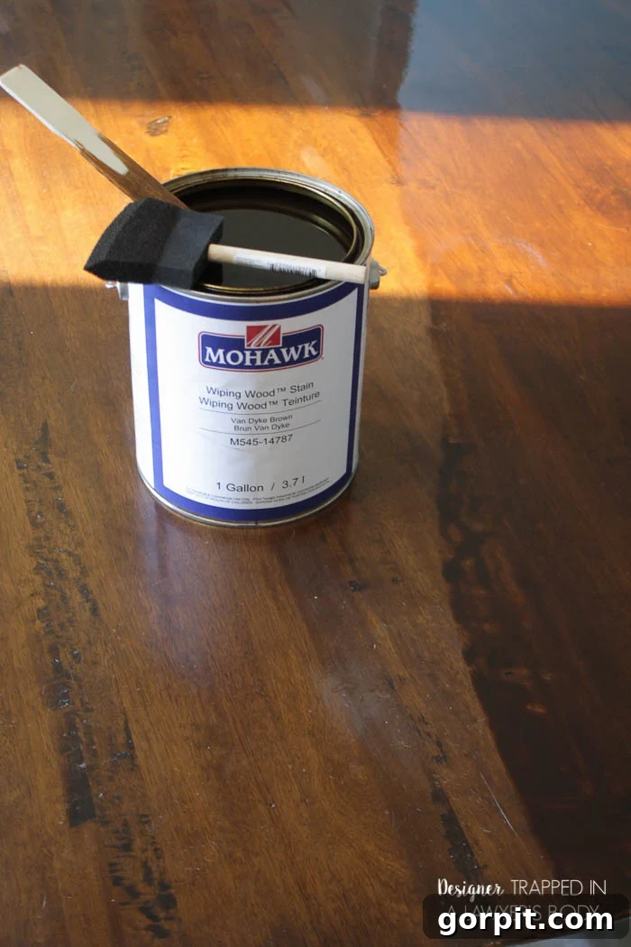 Applying Mohawk Wiping Wood Stain to a wooden table with a foam brush.
