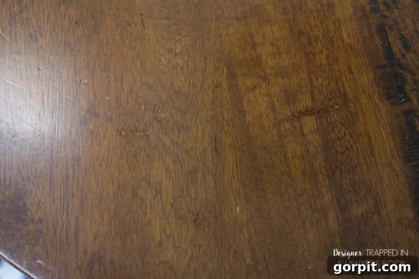 Close-up of a beautifully refinished wood tabletop, showing seamless repairs.
