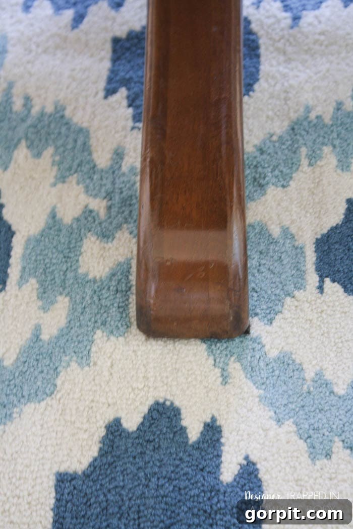 Close-up of a beautifully refinished table leg, highlighting the restored wood grain.