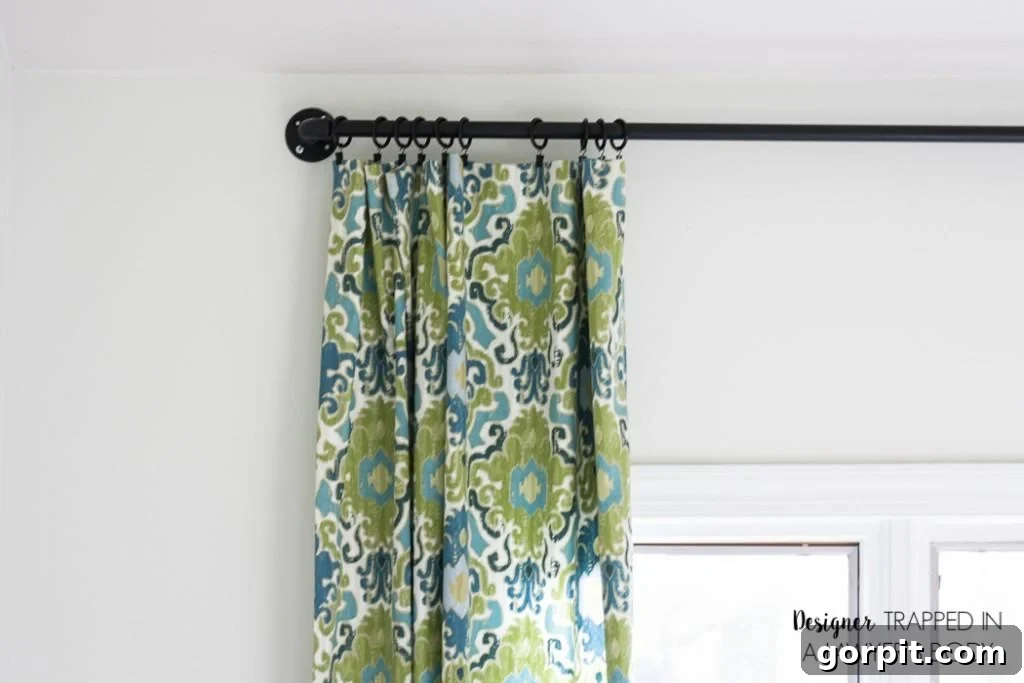 Easy DIY Curtains 9 Adding drapery clips to DIY curtains. The final step before hanging your custom-made, easy curtain panels.