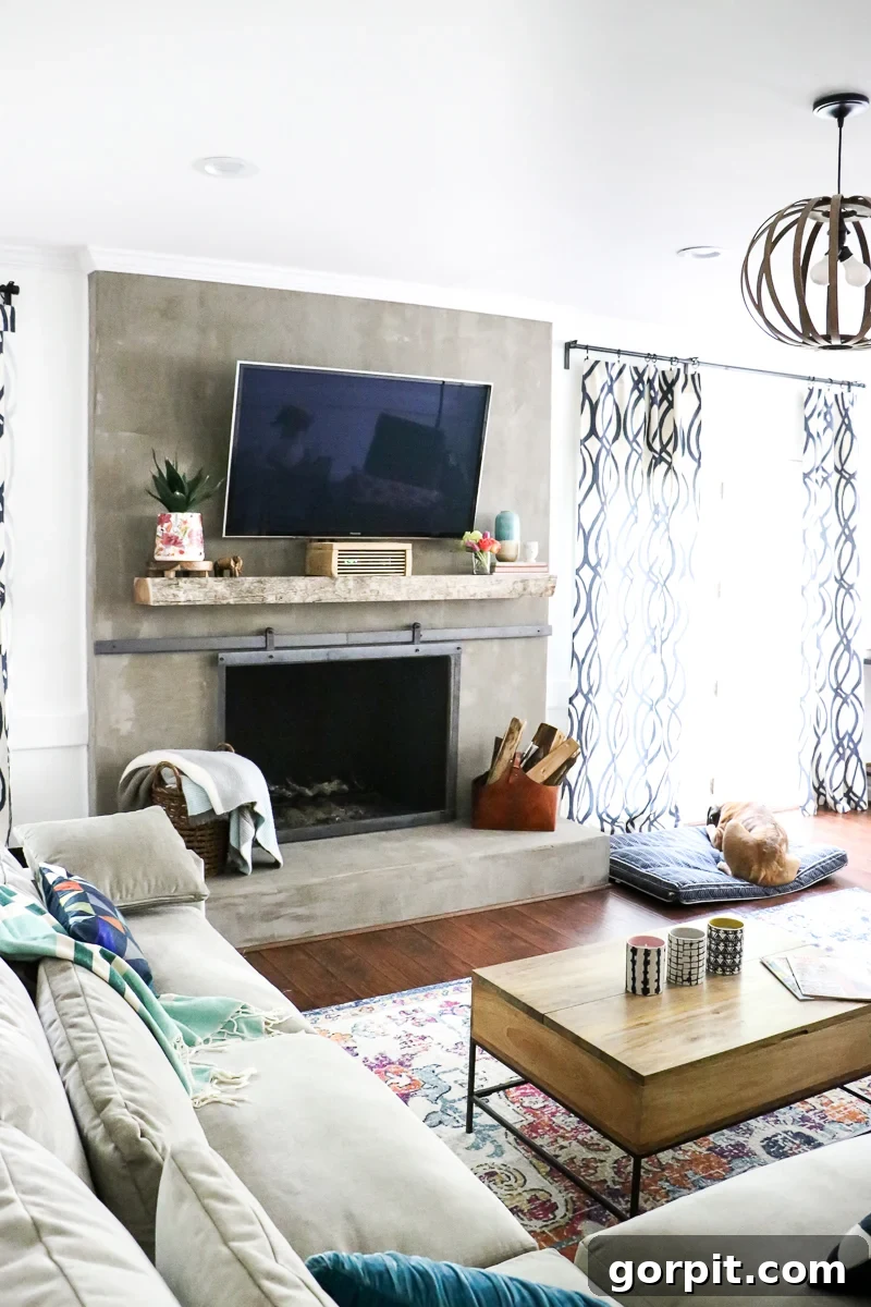 A vibrant family room featuring a completed DIY concrete fireplace, adorned with colorful decor.
