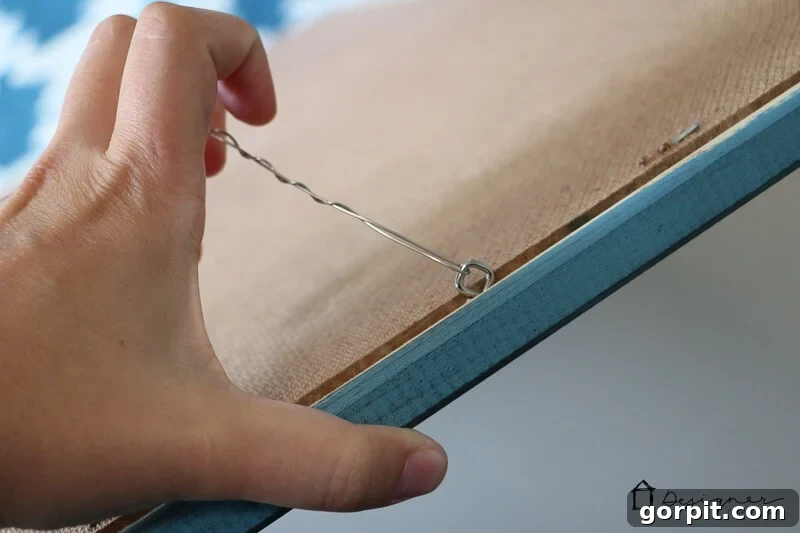 Attaching hanging wire and eye hooks to DIY frame