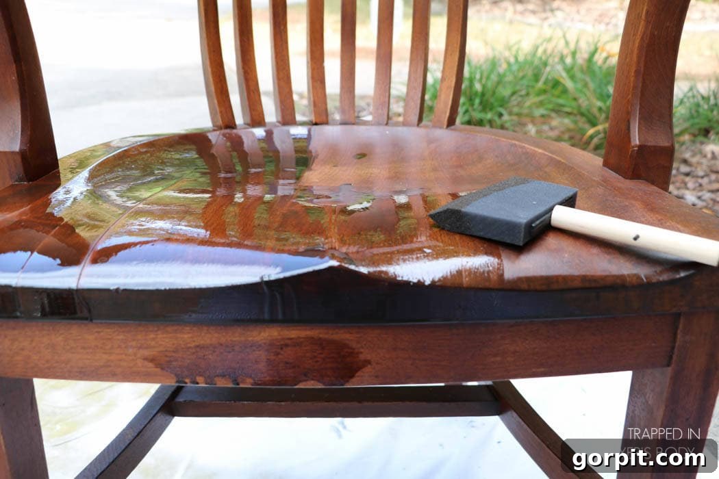 Revitalize Your Wood Chairs Effortlessly 11 Wiping off excess Mohawk Wiping Wood Stain from a chair seat for an even finish
