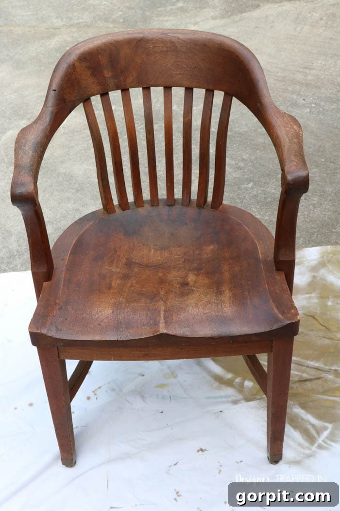 Revitalize Your Wood Chairs Effortlessly 3 Before photo of a wood chair seat with noticeable staining and color variation needing refinishing