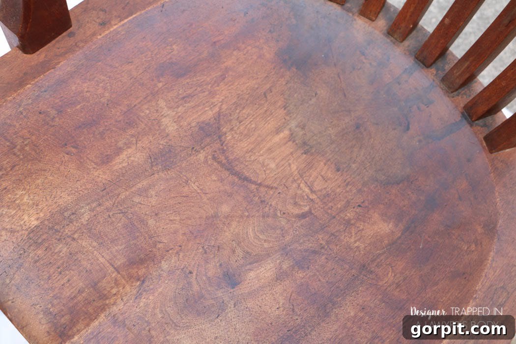 Revitalize Your Wood Chairs Effortlessly 4 Overhead view of a distressed wood chair seat before no-sanding refinishing