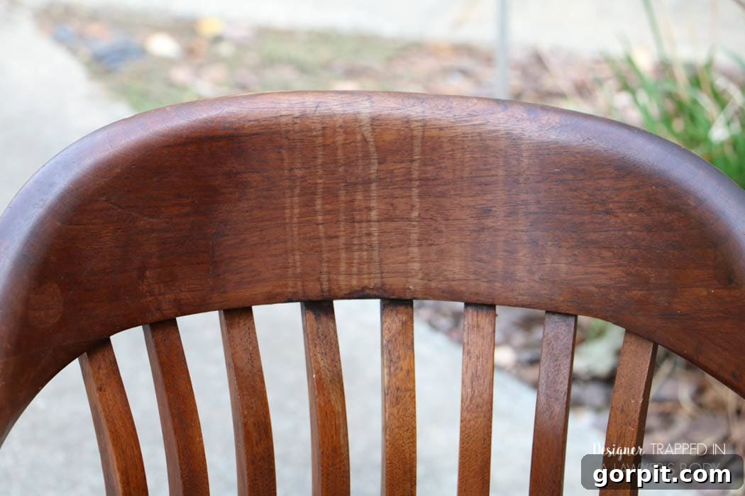 Revitalize Your Wood Chairs Effortlessly 6 Close-up of a wood chair back with severe drip marks before no-sanding refinishing