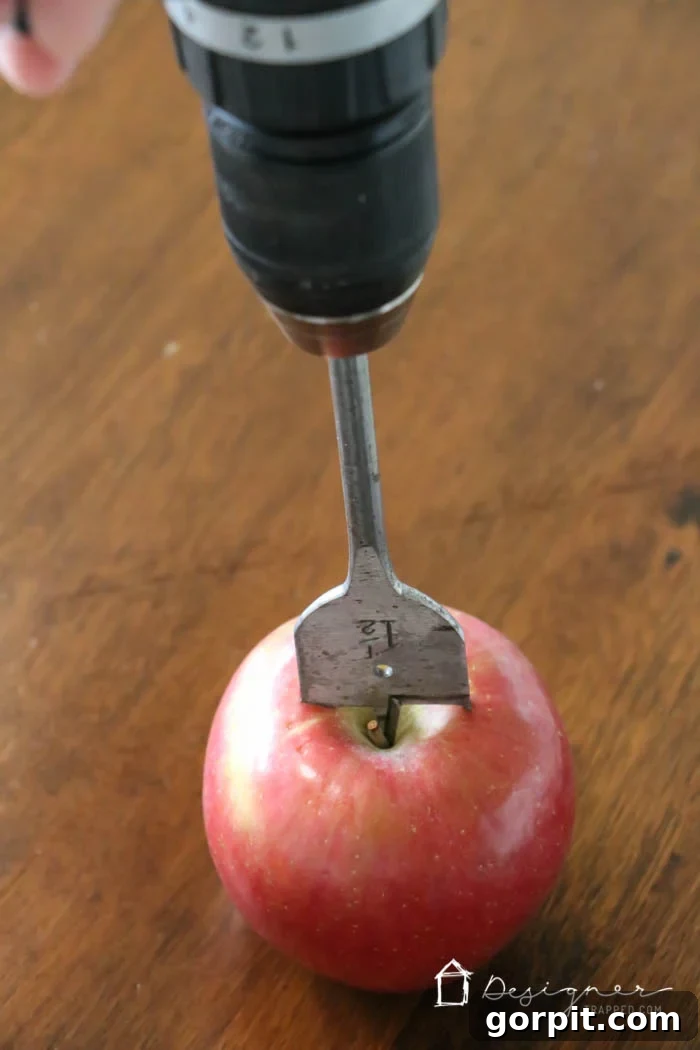 Sweet-Scented Apple Candles: Your DIY Guide 3 Using a paddle drill bit to create a tea light holder in a fresh apple
