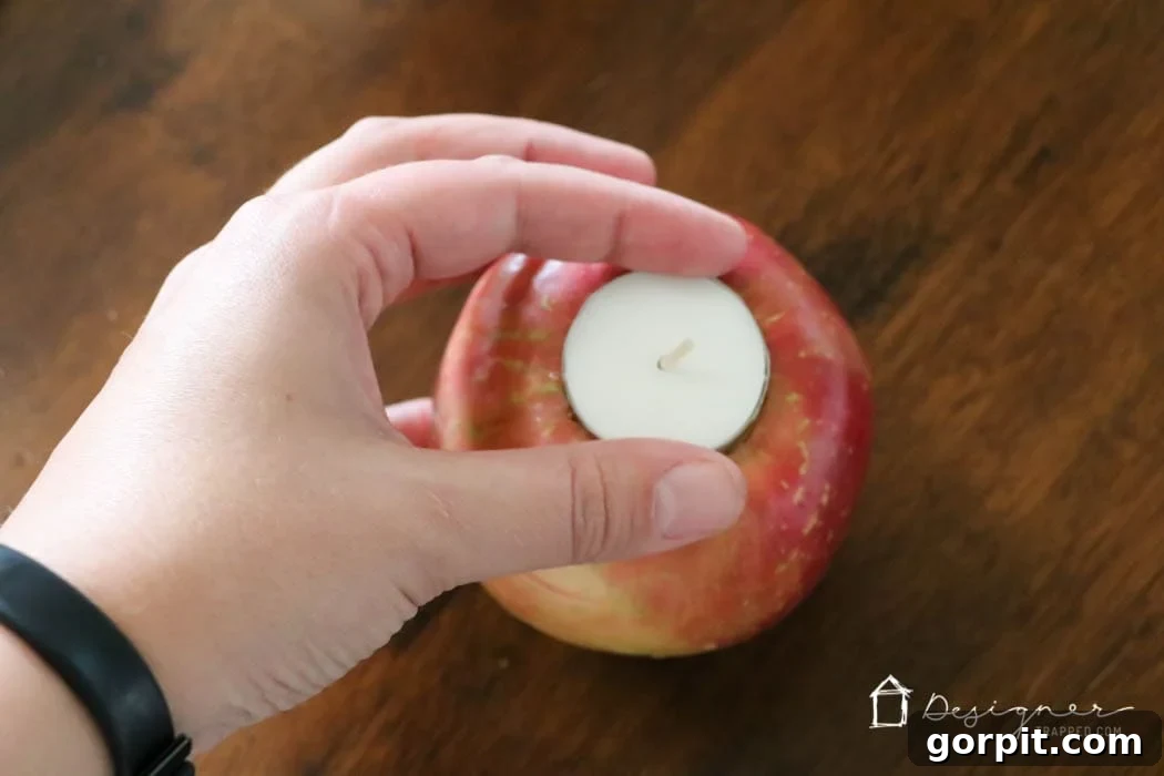 Sweet-Scented Apple Candles: Your DIY Guide 5 Fresh apples transformed into tea light candle holders as a charming table centerpiece