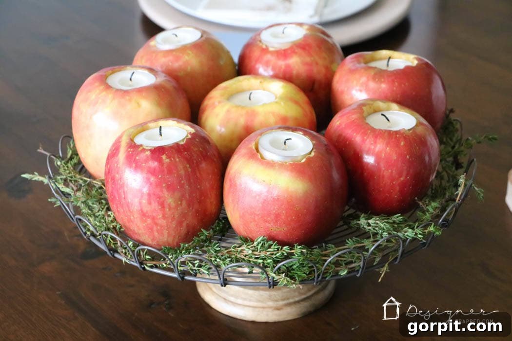 Sweet-Scented Apple Candles: Your DIY Guide 8 Fresh herbs elegantly surrounding fresh apples transformed into tealight candle holders in a festive table centerpiece